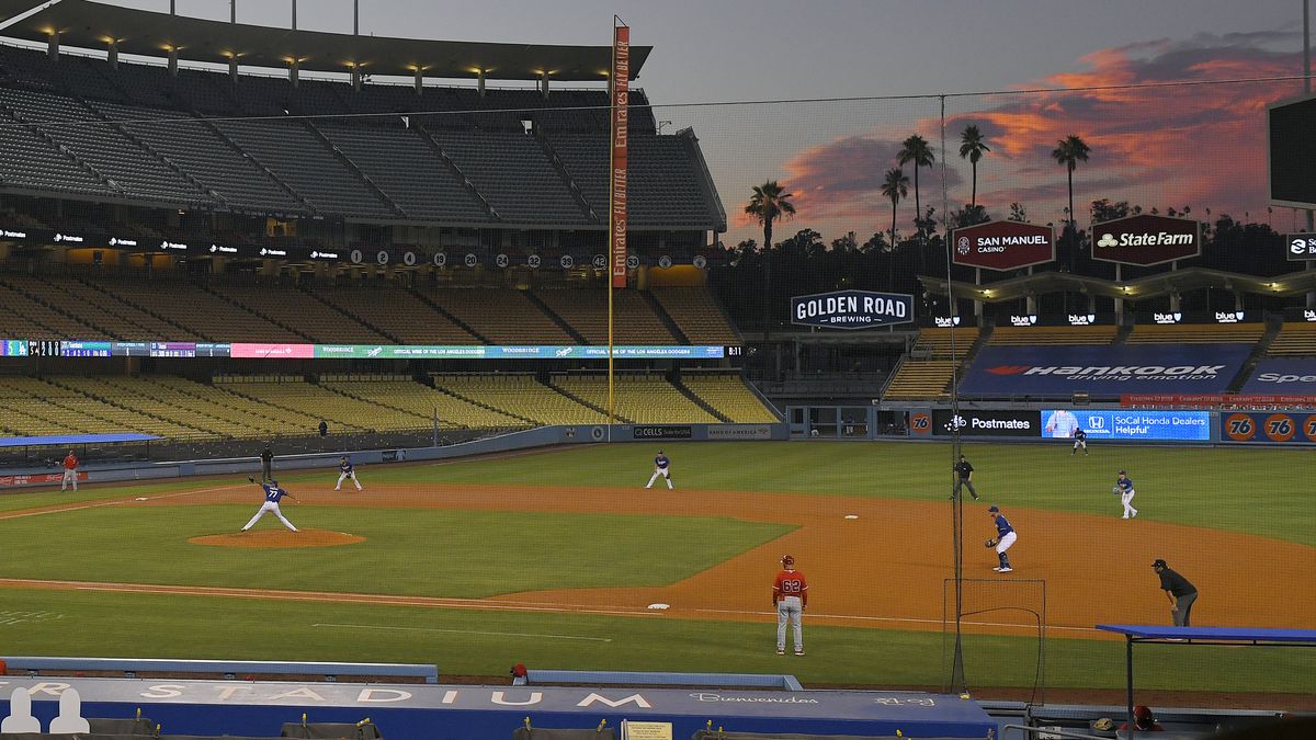 The Los Angeles Dodgers play the Los Angeles Angels at sunset during the fifth inning of a...