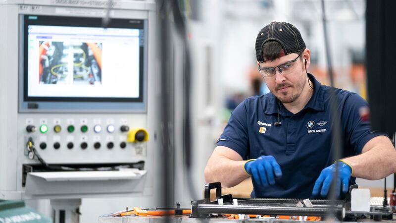 FILE - An employee works in the battery assembly hall at the BMW Spartanburg plant in Greer,...