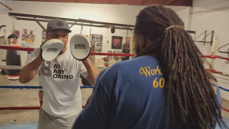 Coach Bombay Higginbottom (L) trains with Pearl boxer Keshaun Davis (R) ahead of Davis' fight...
