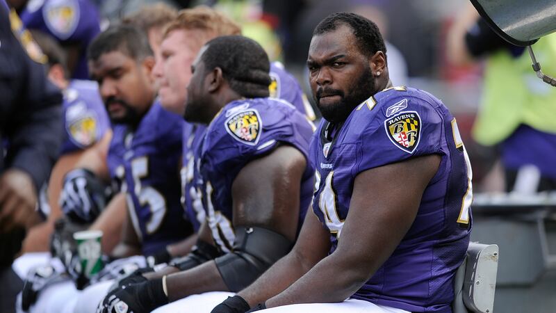 FILE - Baltimore Ravens offensive tackle Michael Oher sits on the beach during the first half...