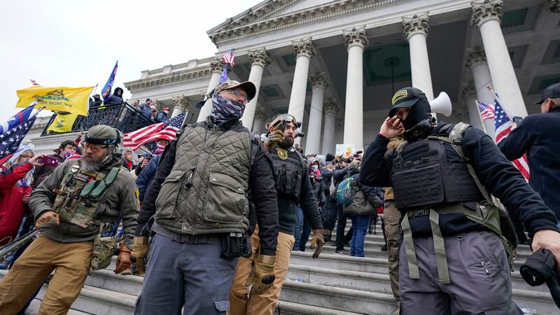 FILE - Members of the Oath Keepers stand on the East Front of the U.S. Capitol on Jan. 6,...