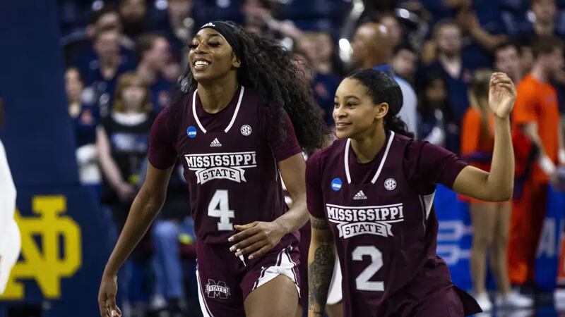 Mississippi State's Jessika Carter (4) and JerKaila Jordan (2) celebrate the team's win over...
