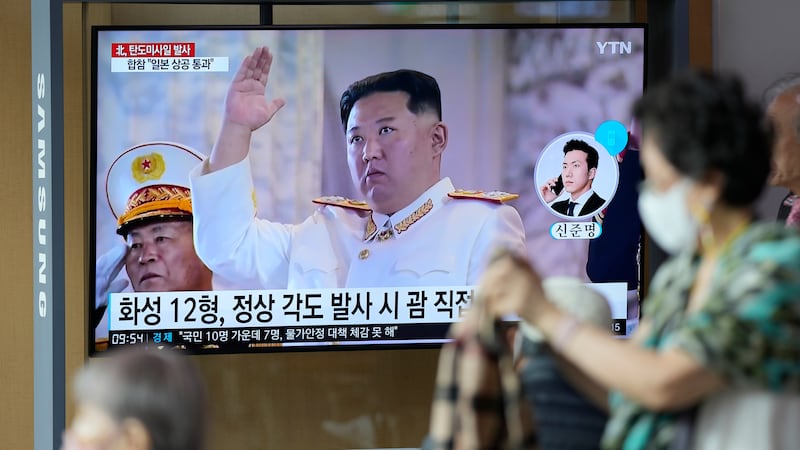 A TV screen showing a news program reporting about North Korea's missile launch with file...