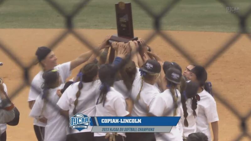 The Co-Lin softball team holds up the championship trophy after their win over Jones College