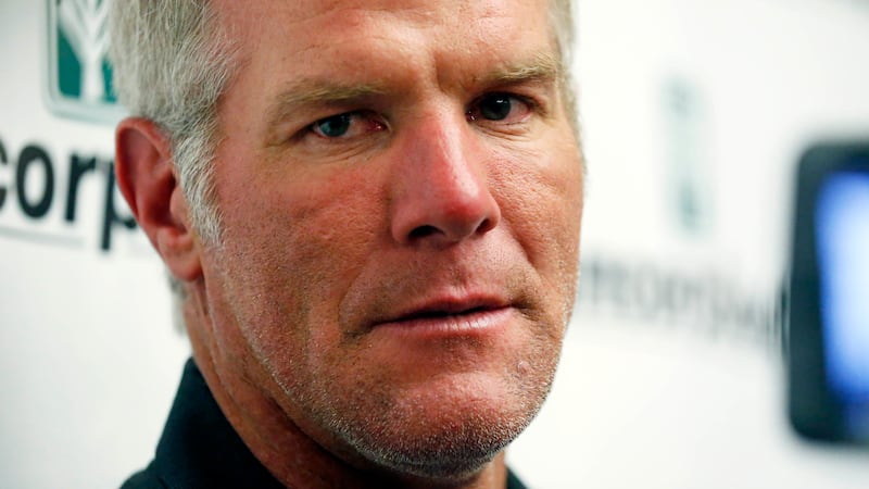 FILE - Former NFL football quarterback Brett Favre speaks with reporters prior to his...